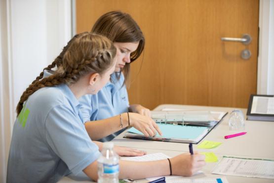 Two young female volunteers working together